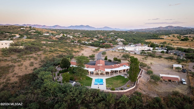 aerial view at dusk featuring a mountain view