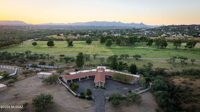 aerial view at dusk featuring a mountain view and a rural view