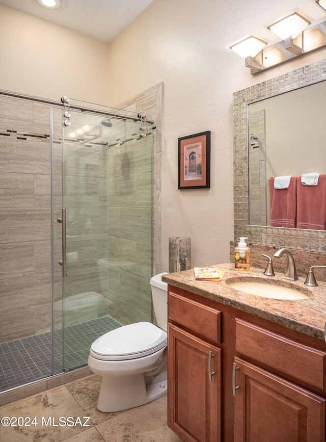 bathroom with vanity, toilet, an enclosed shower, and tile patterned flooring