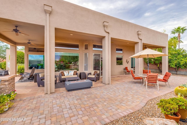 view of patio featuring an outdoor living space with a fire pit and ceiling fan