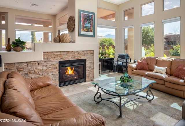 living room featuring a stone fireplace