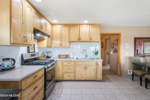 kitchen featuring light brown cabinetry, sink, and stainless steel gas range