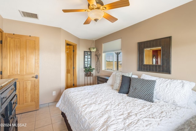 bedroom with ceiling fan and light tile patterned floors