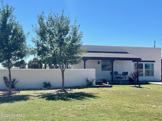 rear view of property with a lawn