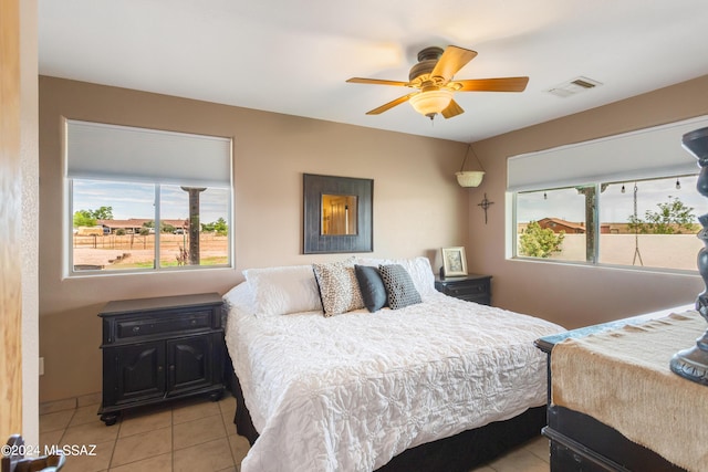 tiled bedroom with ceiling fan