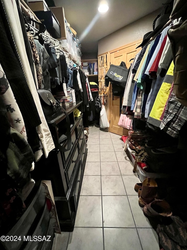 spacious closet with light tile patterned floors