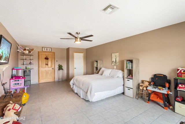 tiled bedroom featuring ceiling fan