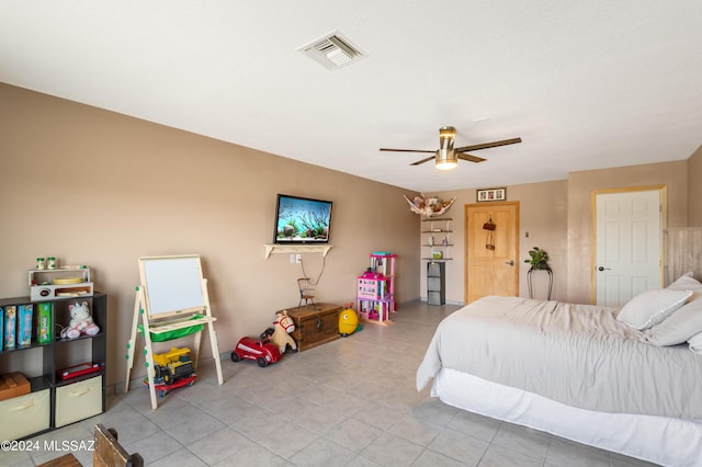 tiled bedroom with ceiling fan