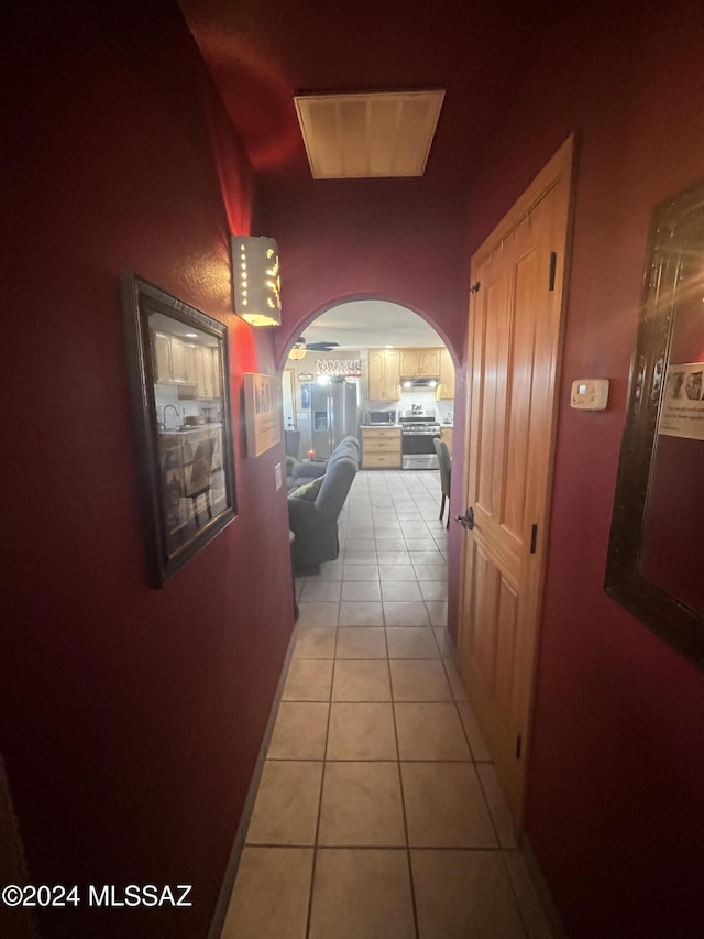 hall with light tile patterned floors