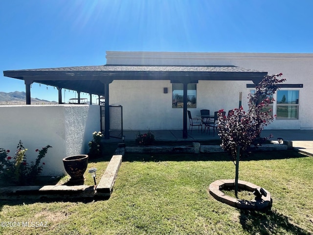 view of property exterior featuring a yard and a patio