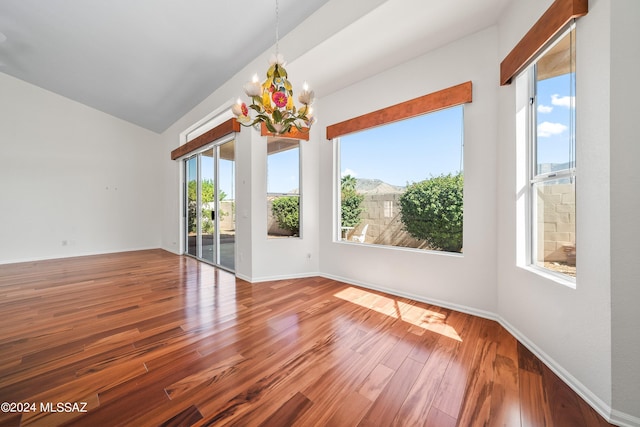 interior space featuring a wealth of natural light, a chandelier, and wood-type flooring