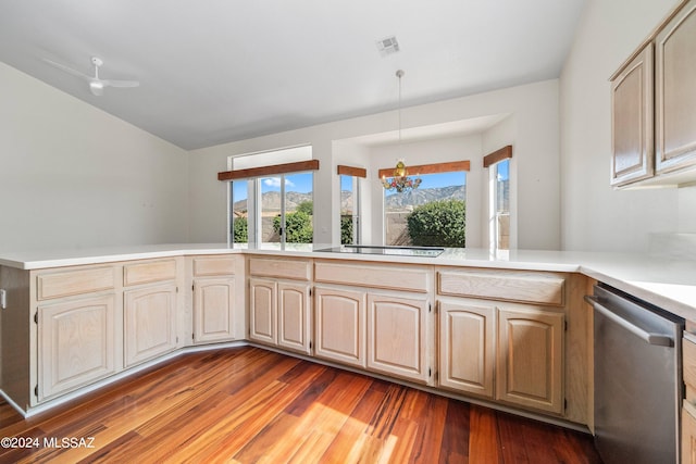 kitchen with black electric stovetop, dark hardwood / wood-style floors, ceiling fan with notable chandelier, kitchen peninsula, and stainless steel dishwasher