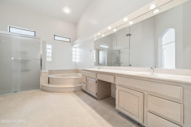 bathroom featuring vanity, lofted ceiling, separate shower and tub, and a wealth of natural light