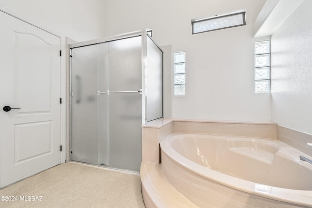 bathroom featuring separate shower and tub