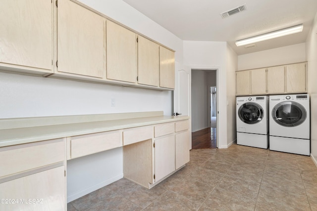 washroom with cabinets and independent washer and dryer