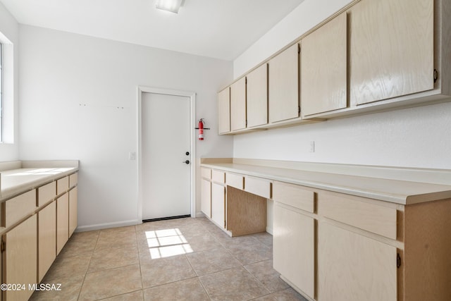 kitchen featuring light brown cabinetry and light tile patterned floors