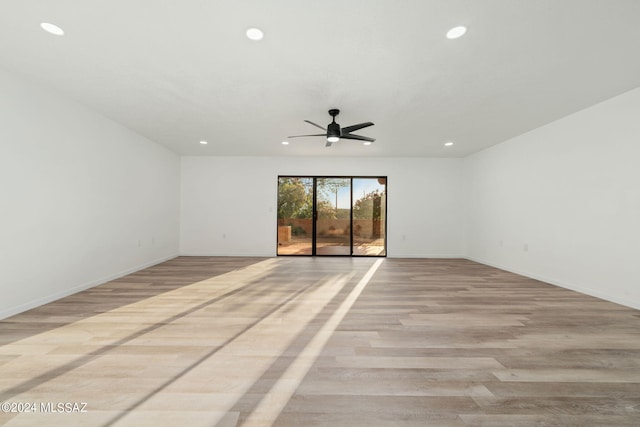 unfurnished room with ceiling fan and light hardwood / wood-style floors