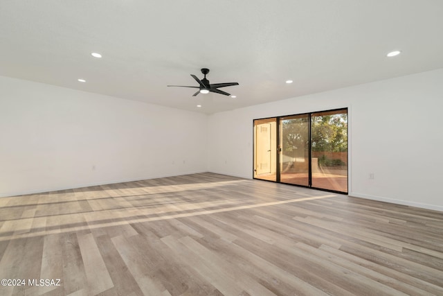 spare room featuring light hardwood / wood-style floors and ceiling fan