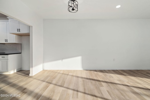 interior space featuring an inviting chandelier and light wood-type flooring