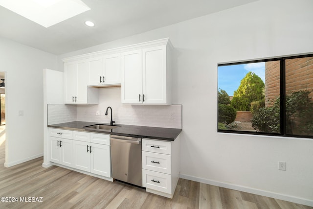 kitchen with dishwasher, white cabinets, light hardwood / wood-style floors, and sink