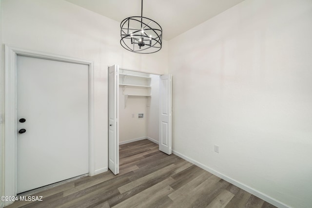 unfurnished dining area with hardwood / wood-style floors and a chandelier