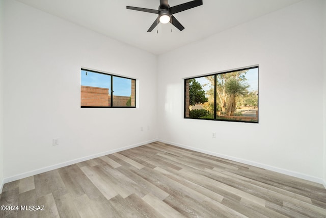 empty room featuring ceiling fan and light hardwood / wood-style floors