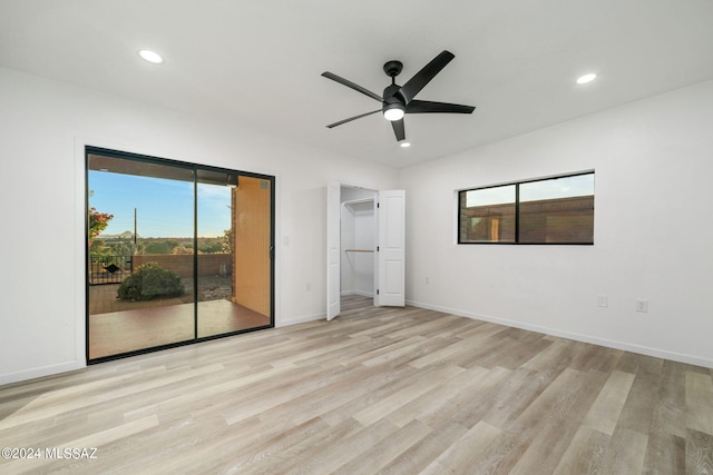 unfurnished bedroom with ceiling fan, a closet, access to outside, and light hardwood / wood-style flooring