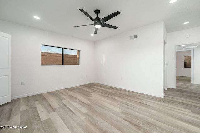 empty room featuring ceiling fan and light hardwood / wood-style flooring