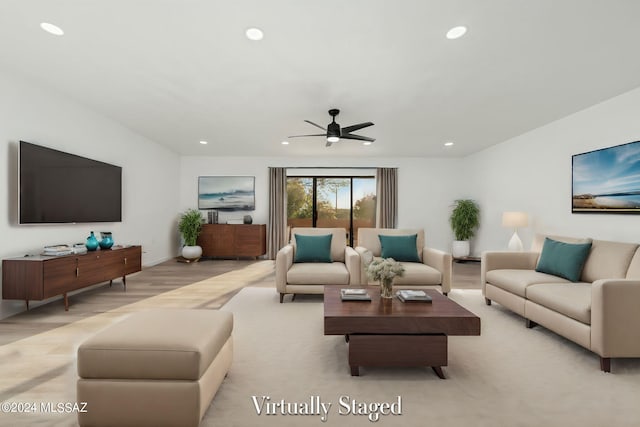 living room with ceiling fan and light colored carpet