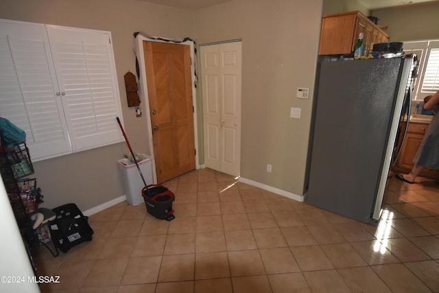 kitchen featuring stainless steel refrigerator and light tile patterned floors