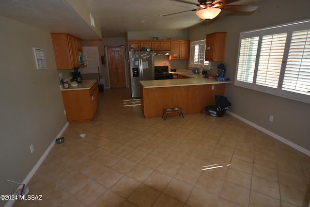 kitchen featuring ceiling fan, exhaust hood, black stove, kitchen peninsula, and stainless steel refrigerator with ice dispenser