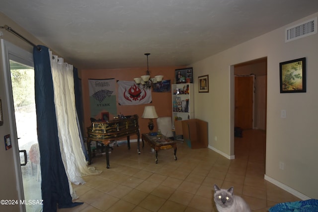 dining room featuring an inviting chandelier and light tile patterned floors