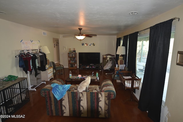 living room with ceiling fan and dark hardwood / wood-style flooring