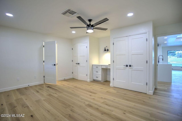 unfurnished bedroom with light wood-type flooring and ceiling fan