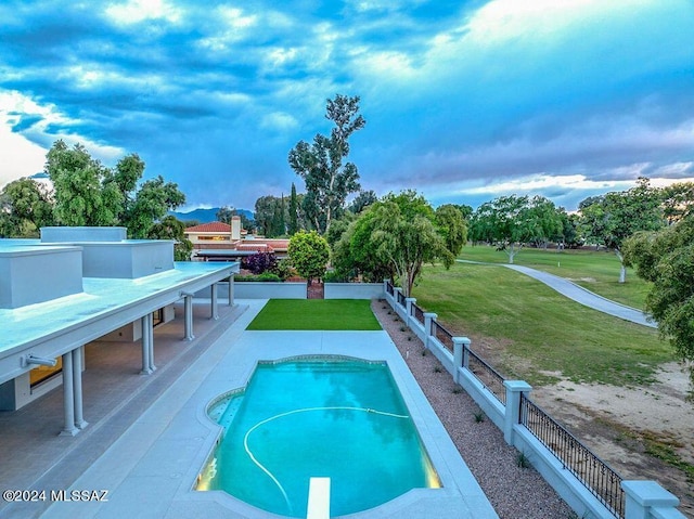 view of pool featuring a diving board and a yard