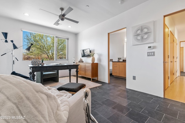 living room featuring ceiling fan and dark hardwood / wood-style flooring