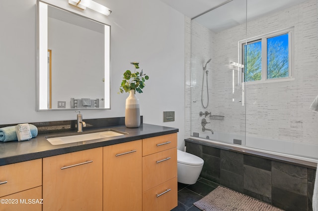 full bathroom with vanity, toilet, tile patterned floors, and tiled shower / bath