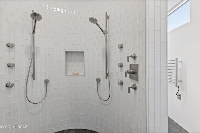 bathroom with tiled shower