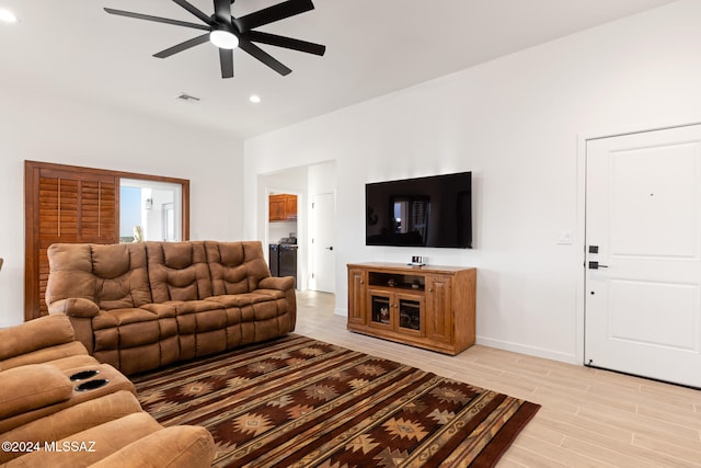 living room with light wood-type flooring and ceiling fan