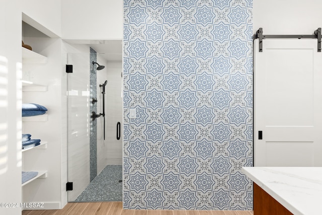 bathroom featuring hardwood / wood-style flooring, vanity, and an enclosed shower