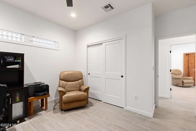 sitting room featuring light hardwood / wood-style flooring and ceiling fan