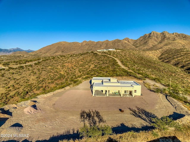 birds eye view of property with a mountain view