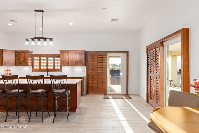 kitchen with hanging light fixtures and light hardwood / wood-style floors