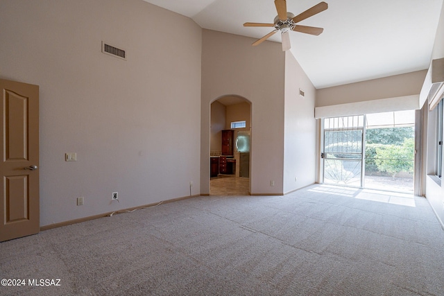 carpeted spare room with high vaulted ceiling and ceiling fan