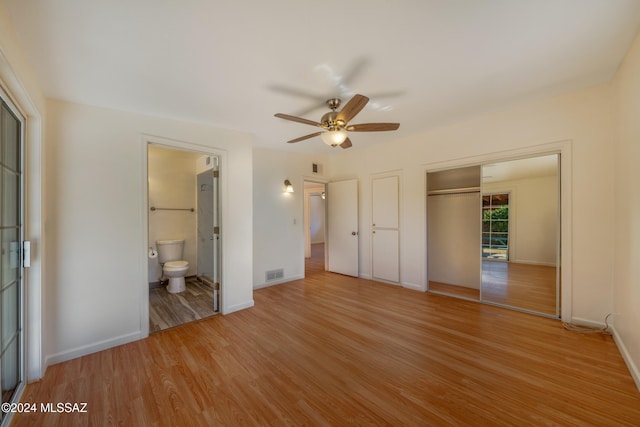 unfurnished bedroom featuring light hardwood / wood-style floors, ensuite bath, and ceiling fan