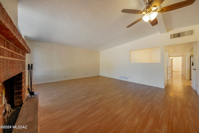 unfurnished living room with vaulted ceiling with beams, ceiling fan, a fireplace, and hardwood / wood-style floors