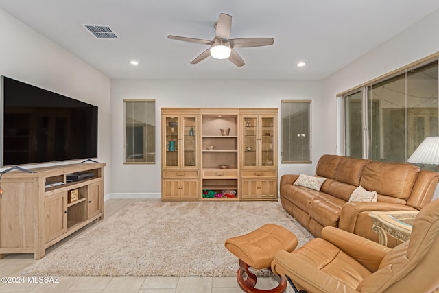 tiled living room with ceiling fan