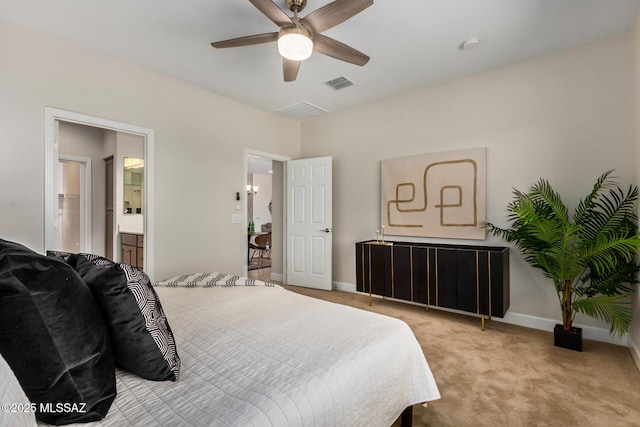 carpeted bedroom featuring baseboards, visible vents, a ceiling fan, and ensuite bathroom