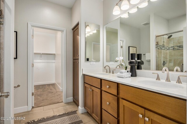 kitchen with sink, an island with sink, a kitchen breakfast bar, appliances with stainless steel finishes, and decorative light fixtures