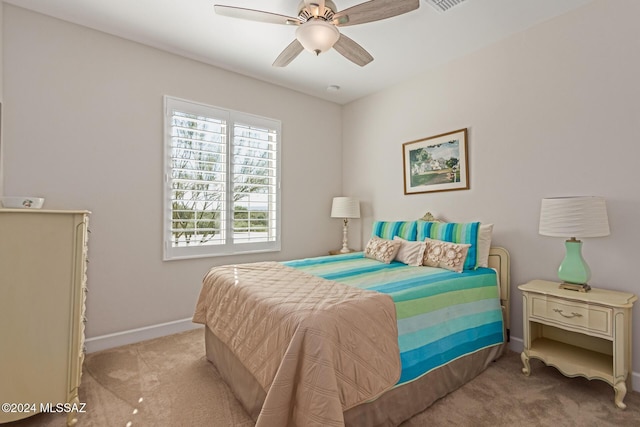 carpeted bedroom with visible vents, ceiling fan, and baseboards